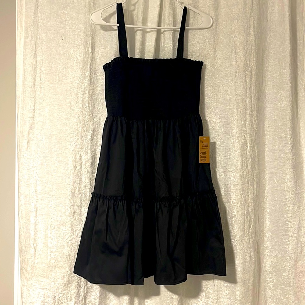 Black dress with back details and ruffled bottom. Size Large.